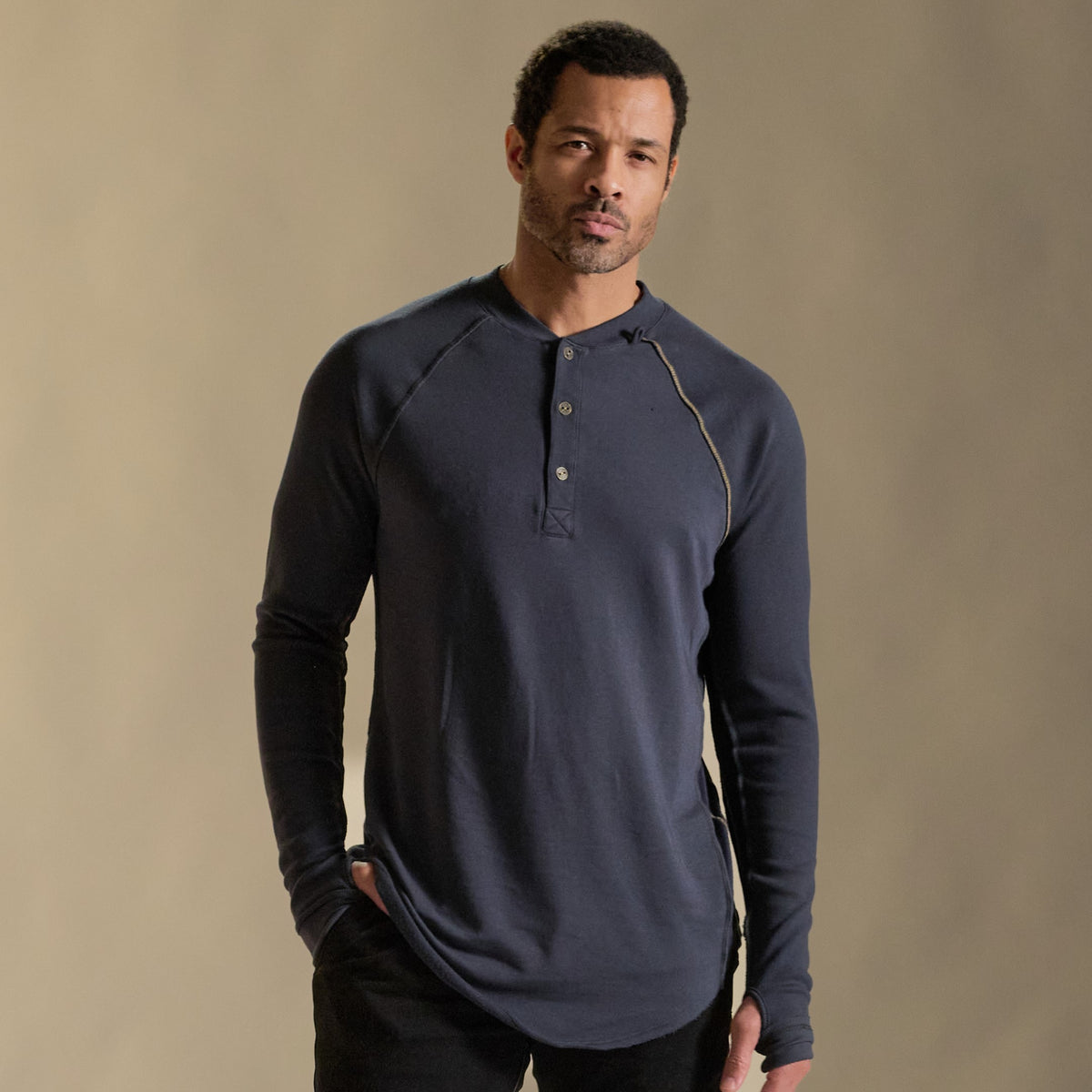 Male modeling blue long sleeve henley