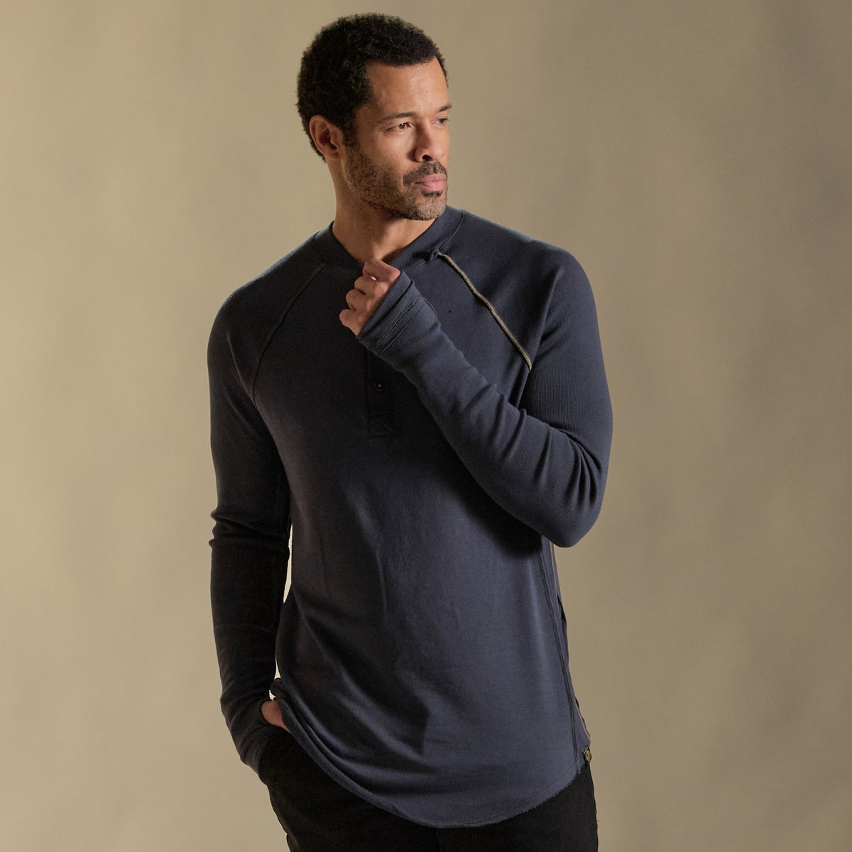 Male modeling blue long sleeve henley
