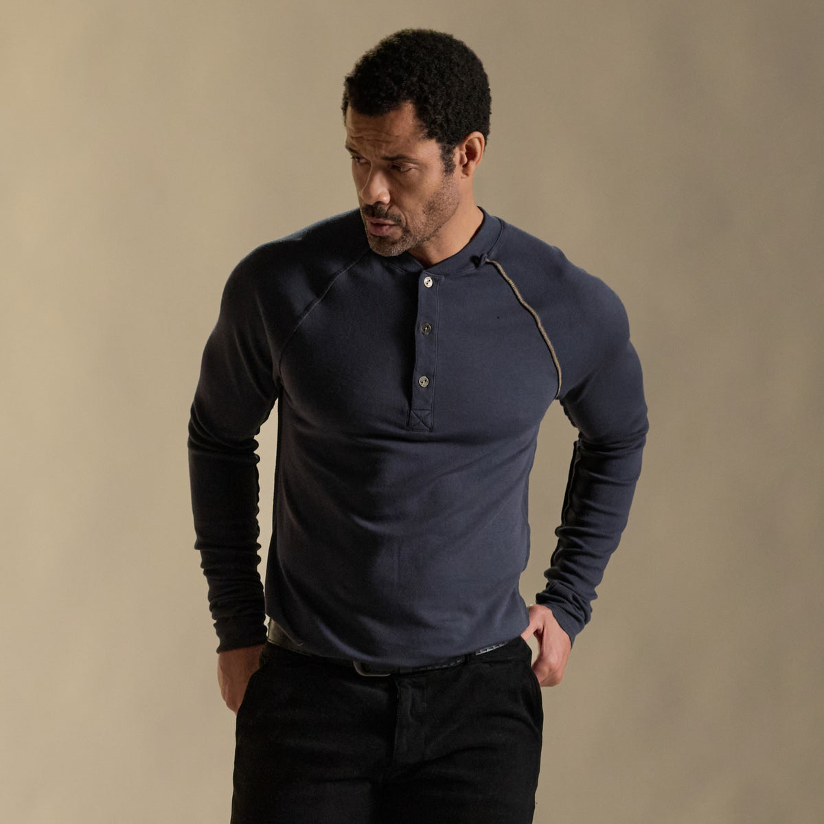 Male modeling blue long sleeve henley