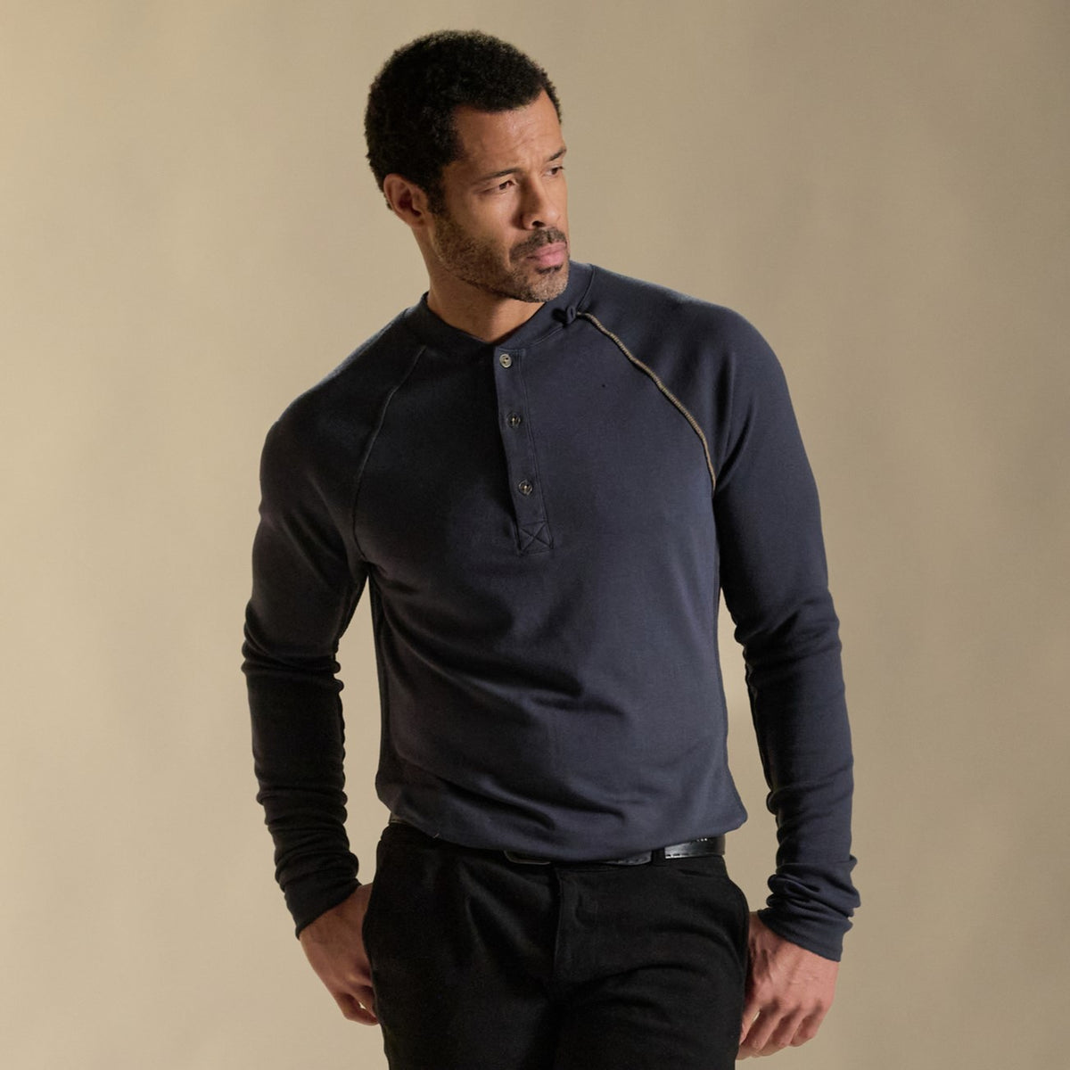 Male modeling blue long sleeve henley