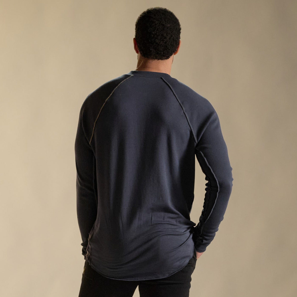 Male modeling blue long sleeve henley