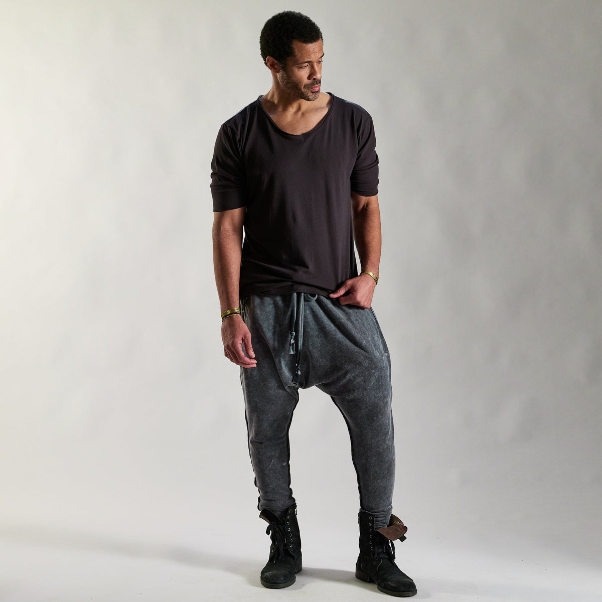 A man modeling tree pant in mineral wash