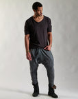 A man modeling tree pant in mineral wash