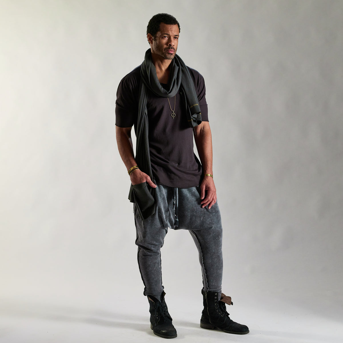 A man modeling tree pant in mineral wash