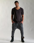 A man modeling tree pant in mineral wash
