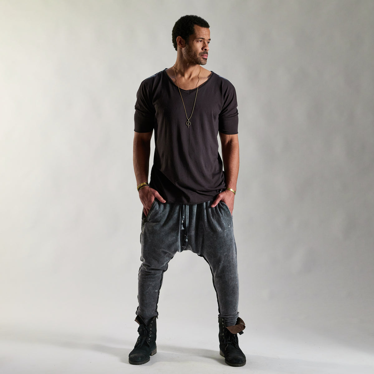 A man modeling tree pant in mineral wash