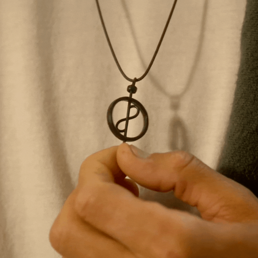 A model spinning the 108 Talisman Black Ceramic Necklace