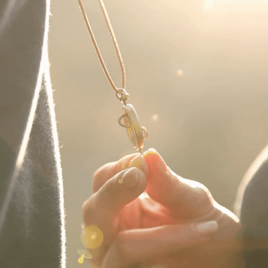 A model spinning the 108 Talisman Antique Gold Necklace