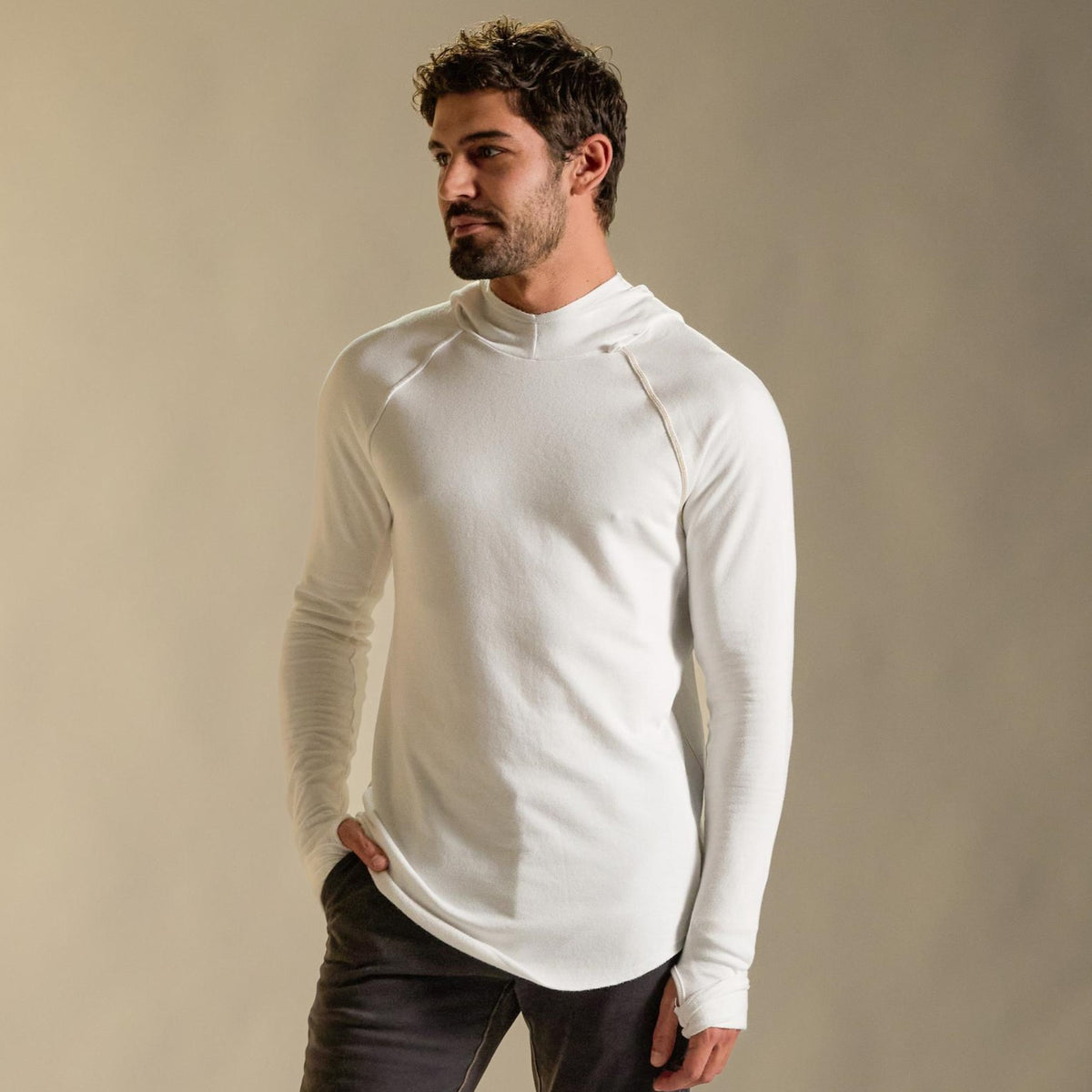Man modeling white long-sleeve hooded tee