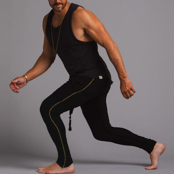 A man modeling black slim tree pants