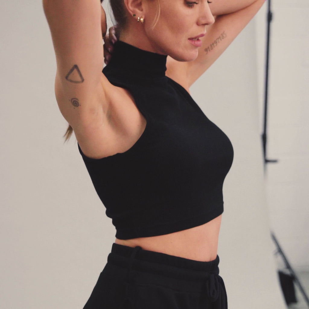 Woman modeling high neck crop in Black