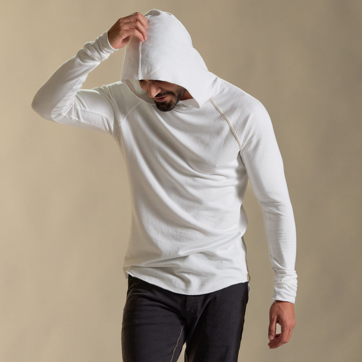 Man modeling white long-sleeve hooded tee