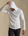 Man modeling white long-sleeve hooded tee