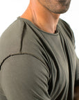 A man wearing the One Golden Thread New Classic Crew reversible t-shirt in Olive color