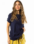A woman wearing the One Golden Thread New Classic Crew t-shirt in Royal Blue color