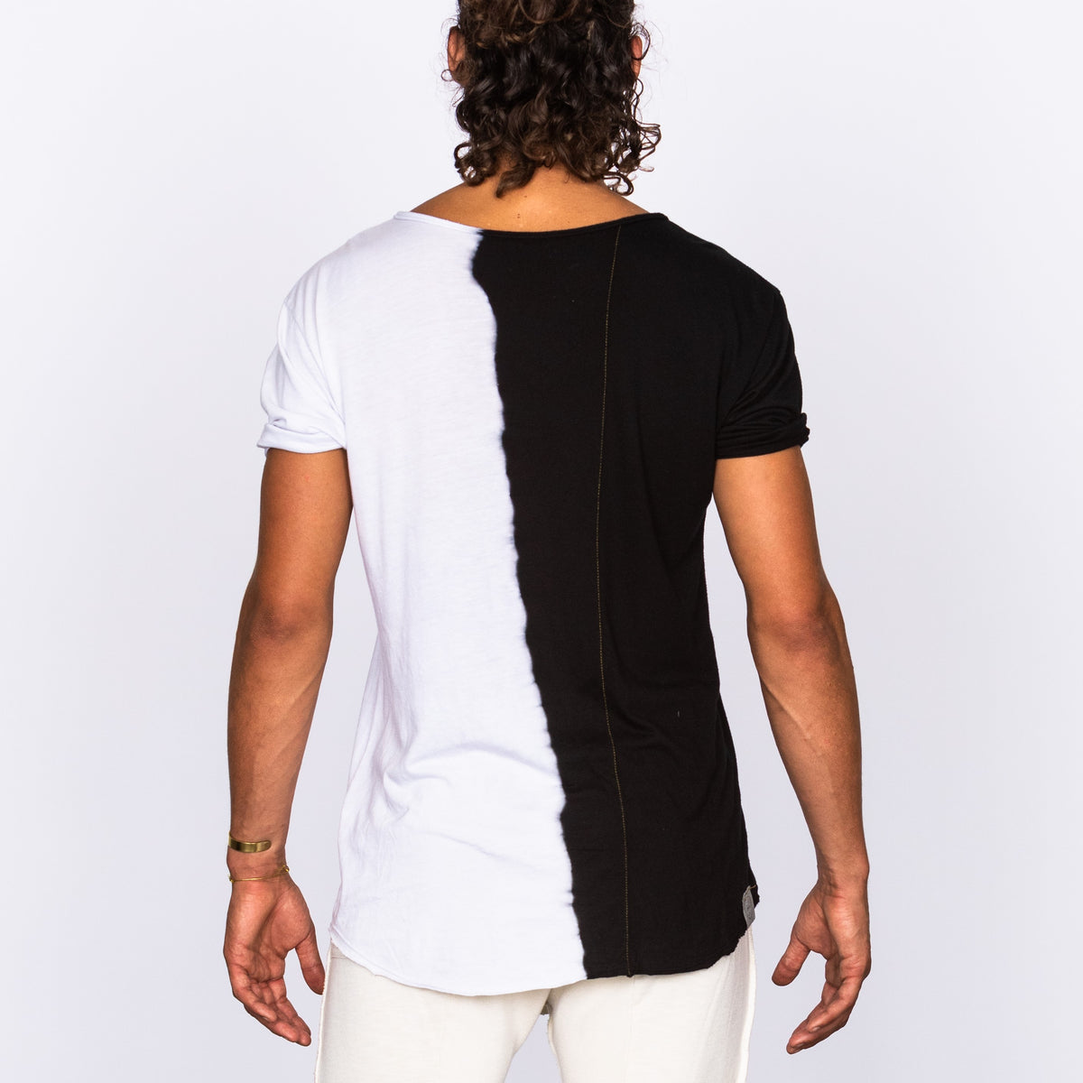 Male modeling half white half black crew neck shirt