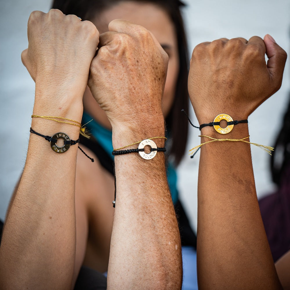 A group of people wearing their Customized MyIntent Black Bracelets with the words "Inner Power" "I Am Golden" and "Inner Peace"