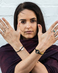 A woman wearing two Customized MyIntent Black Twist Bracelets with the words "Breathe Love" and "Inner Power"