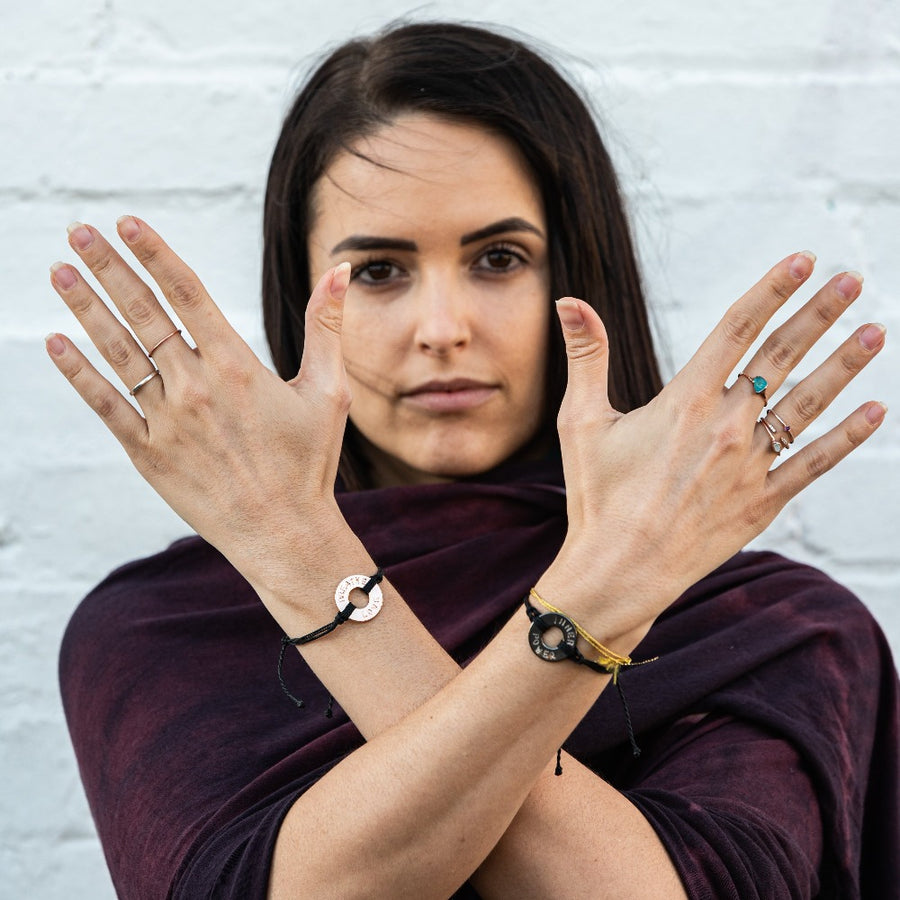 A woman wearing two Customized MyIntent Black Twist Bracelets with the words "Breathe Love" and "Inner Power"