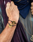 A man wearing customized MyIntent black bracelets with the words "Grateful" and "Breathe"