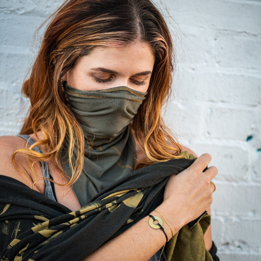 A woman wearing a Customized MyIntent Gold Plated Black Twist Bracelet