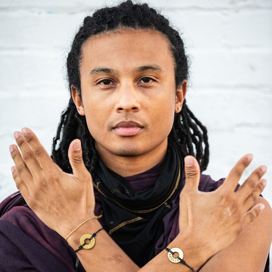 A man wearing two Customized MyIntent Black Twist Bracelets with the words "Breathe" and "Grateful"