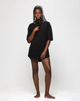 A woman wearing the One Golden Thread Fleece Sweater t-shirt in the Black Onyx color