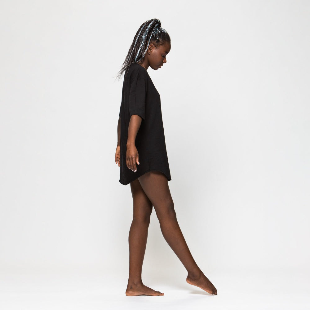 A woman wearing the One Golden Thread Fleece Sweater v neck shirt in the Black Onyx color