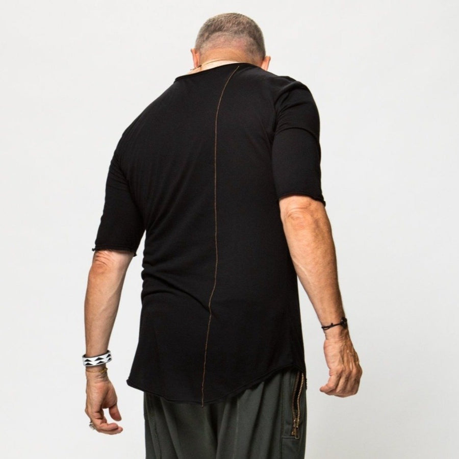 A man wearing the One Golden Thread Raw V Tree Shirt in Black Onyx color