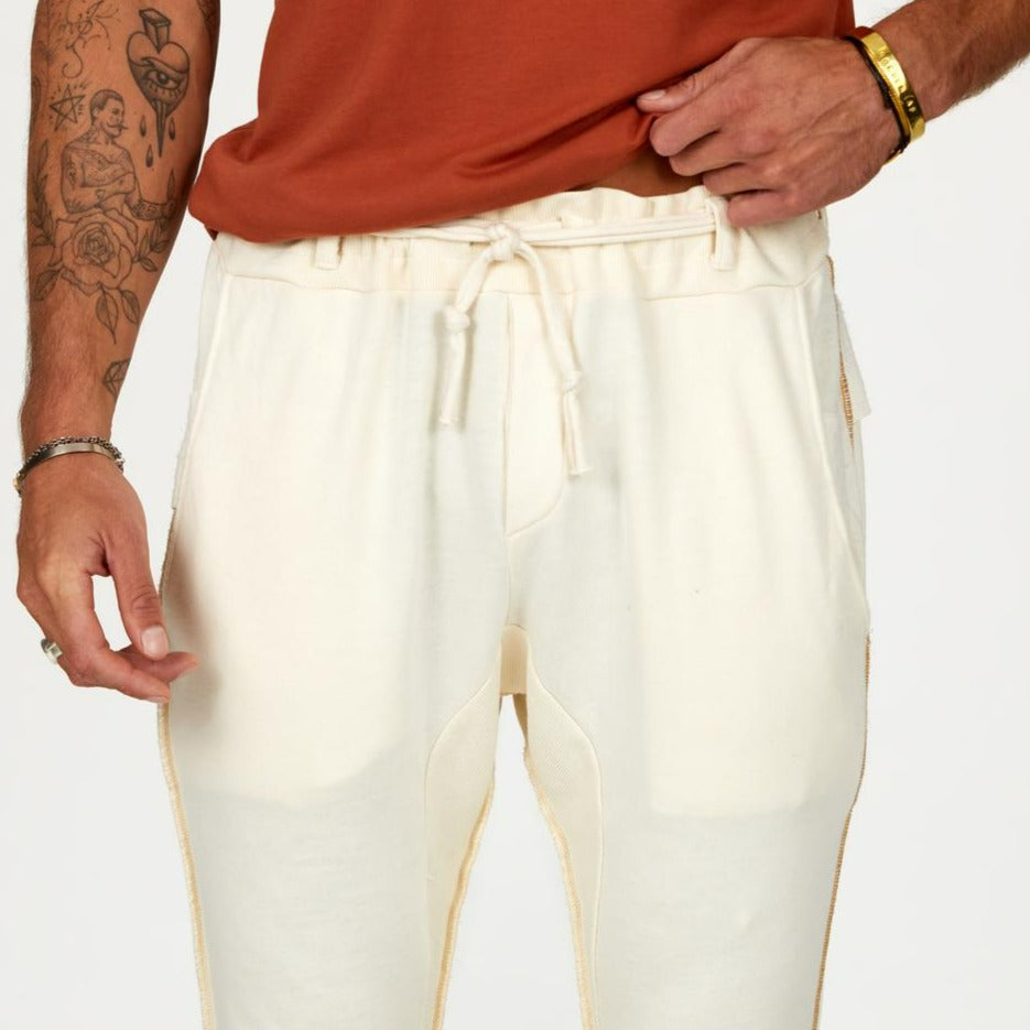 Man modeling the milano pant in white stone