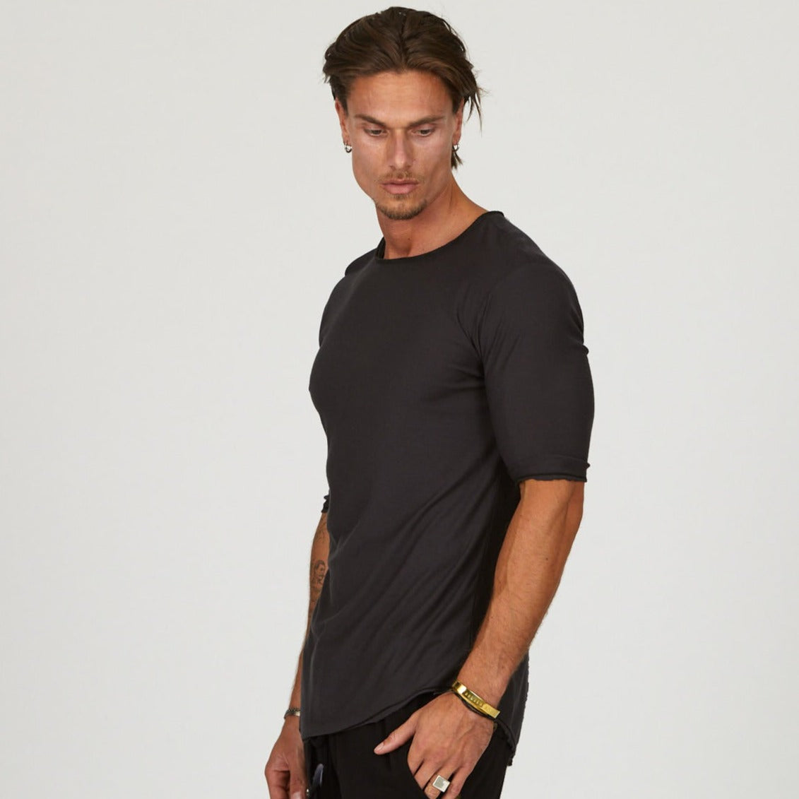 Male modeling black crew neck shirt