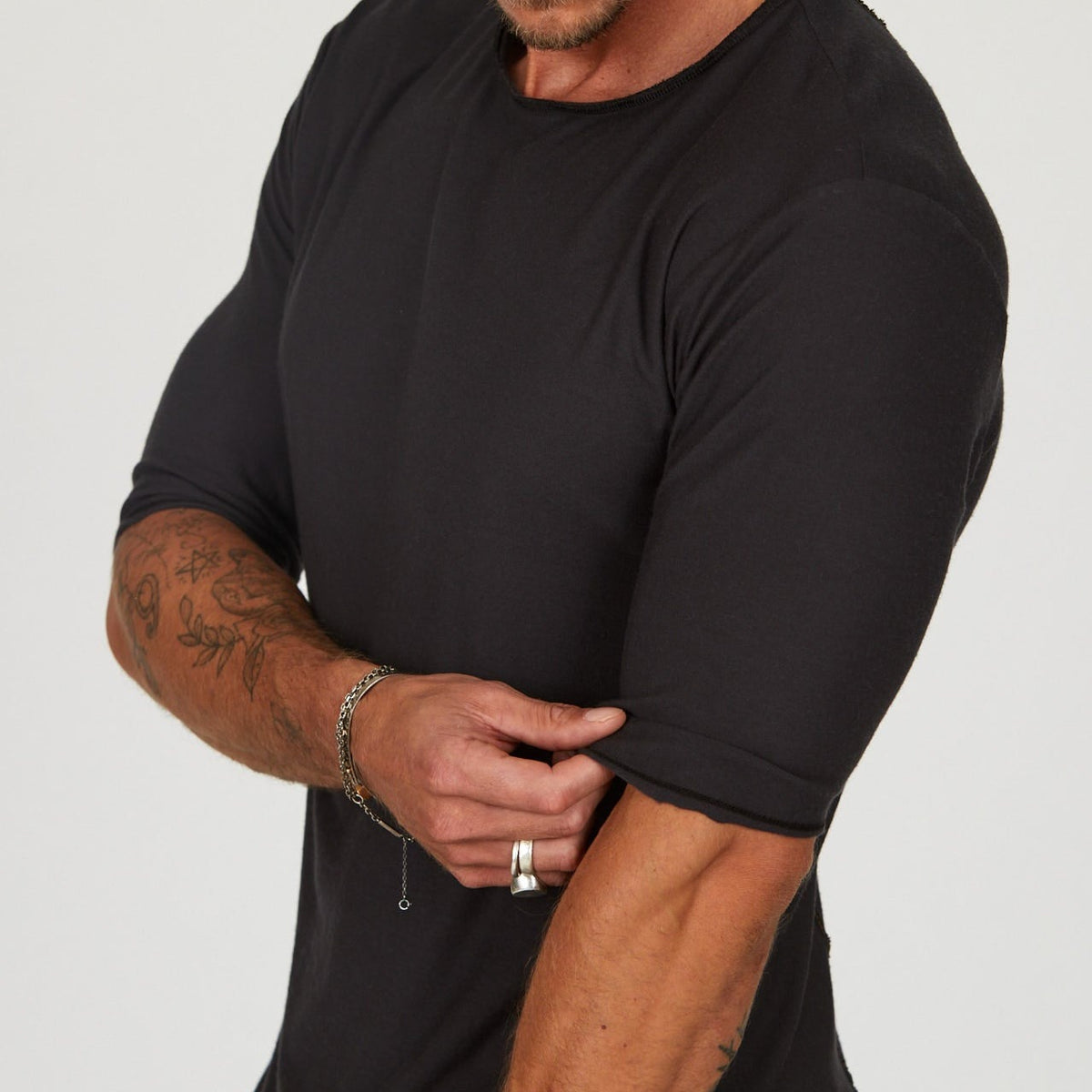 Male modeling black crew neck shirt