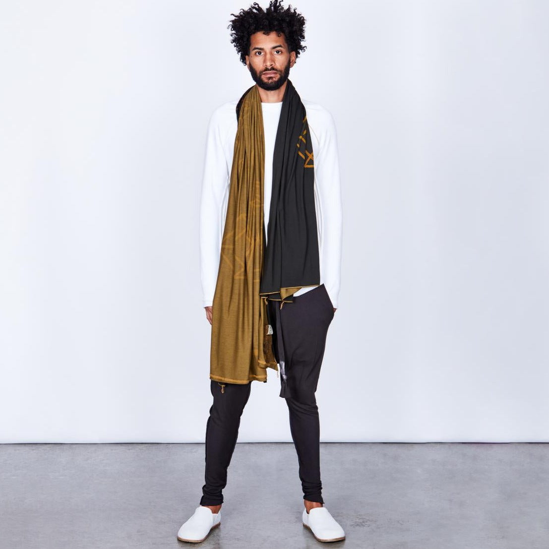 Male modeling gold on black nature wrap