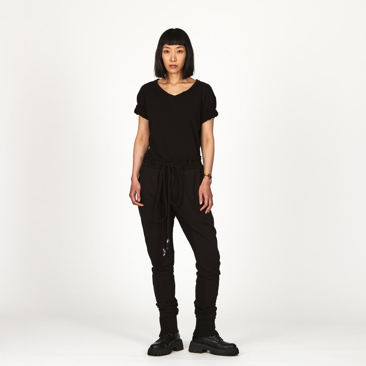 A woman wearing the One Golden Thread Fleece Sweater v neck shirt in the Black Onyx color