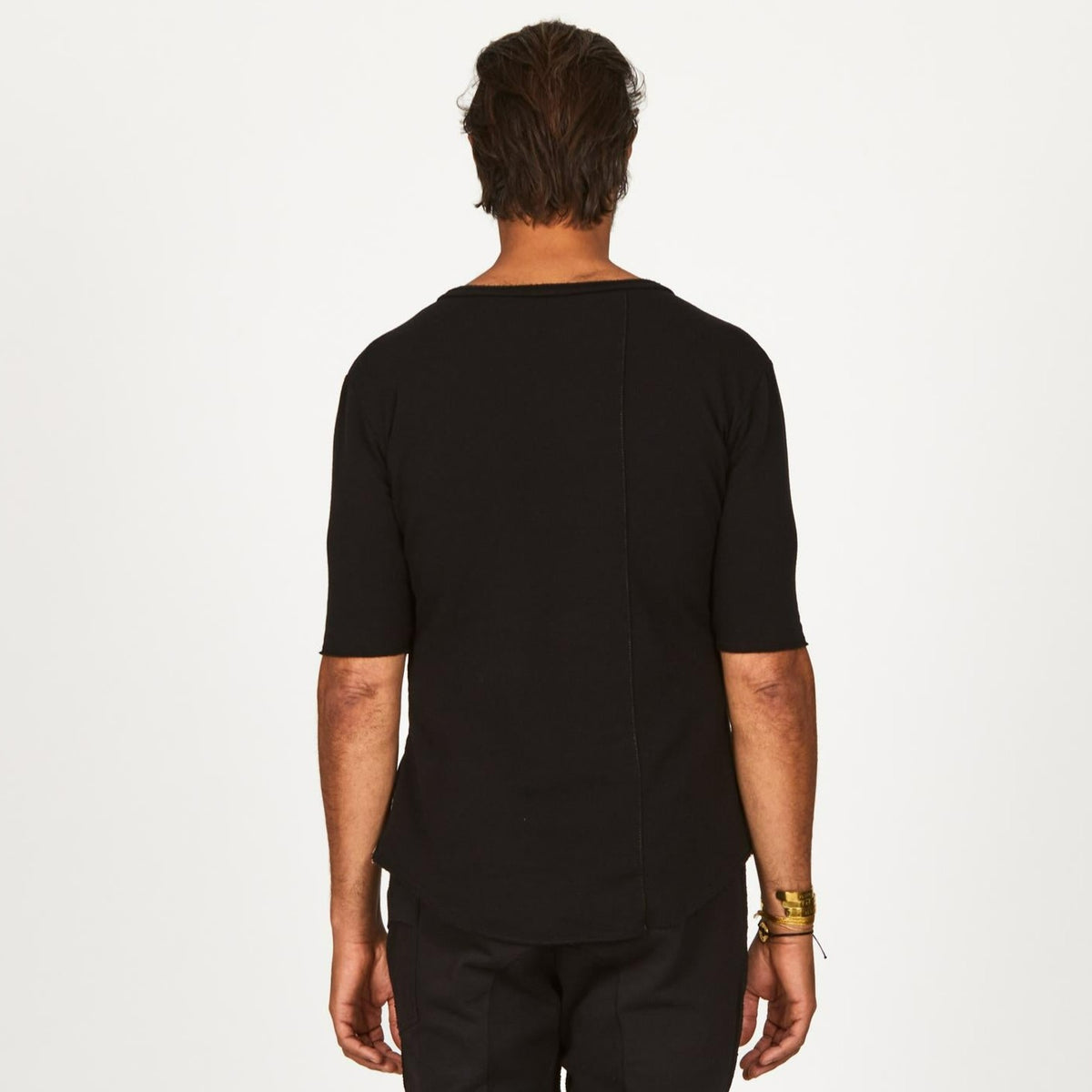 A man modeling in a black sweater v neck shirt