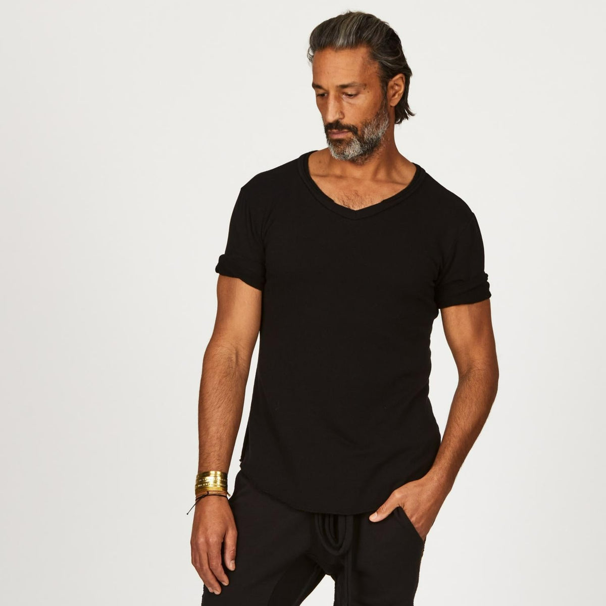A man modeling in a black sweater v neck shirt