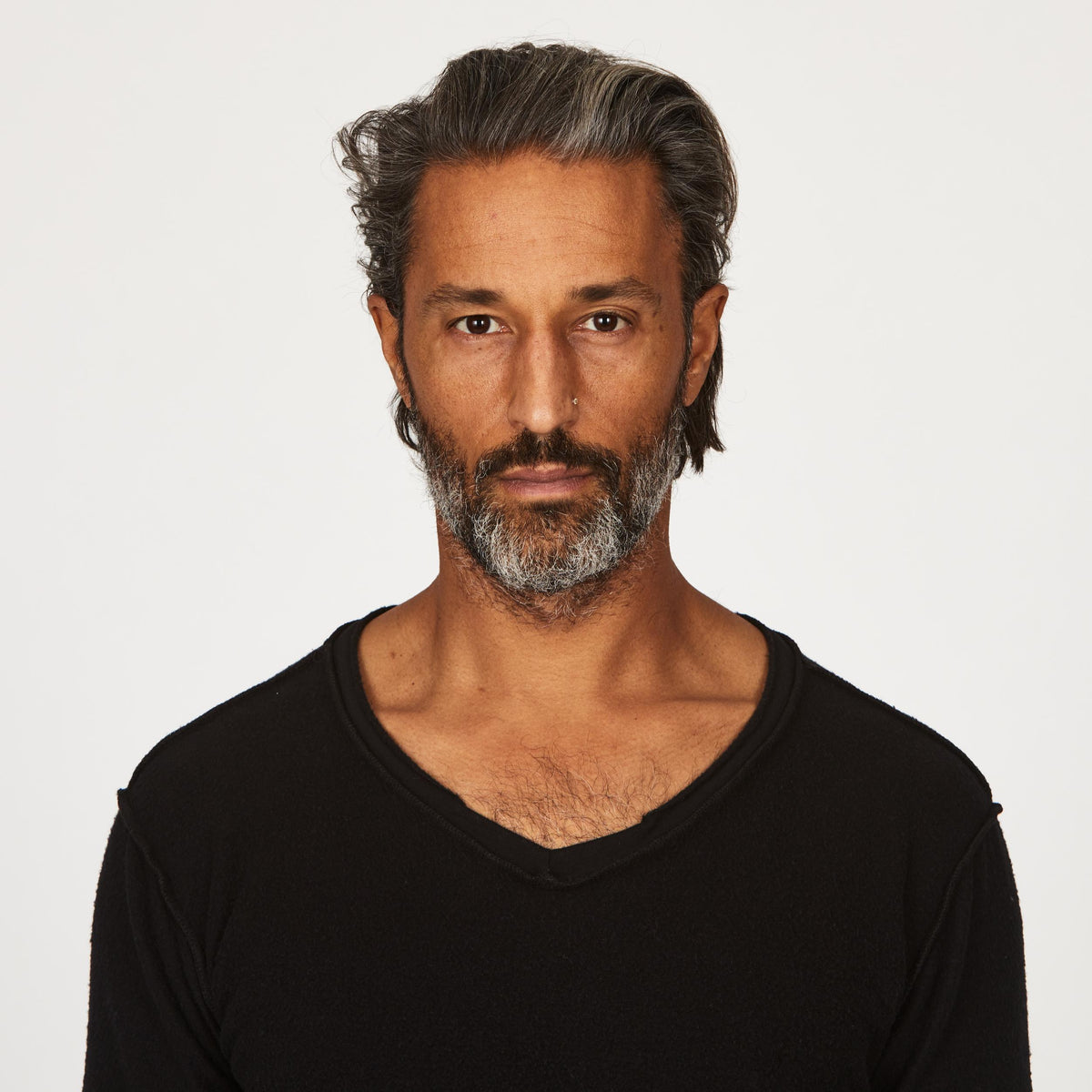 A man modeling in a black sweater v neck shirt