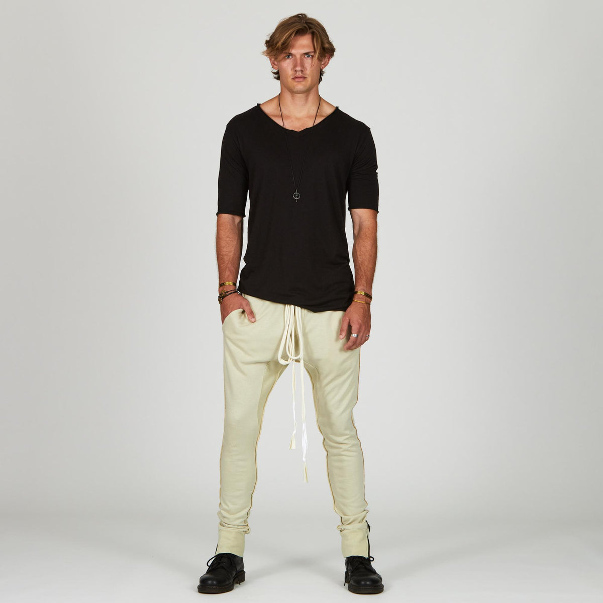 Man modeling the milano pant in ceremony sand