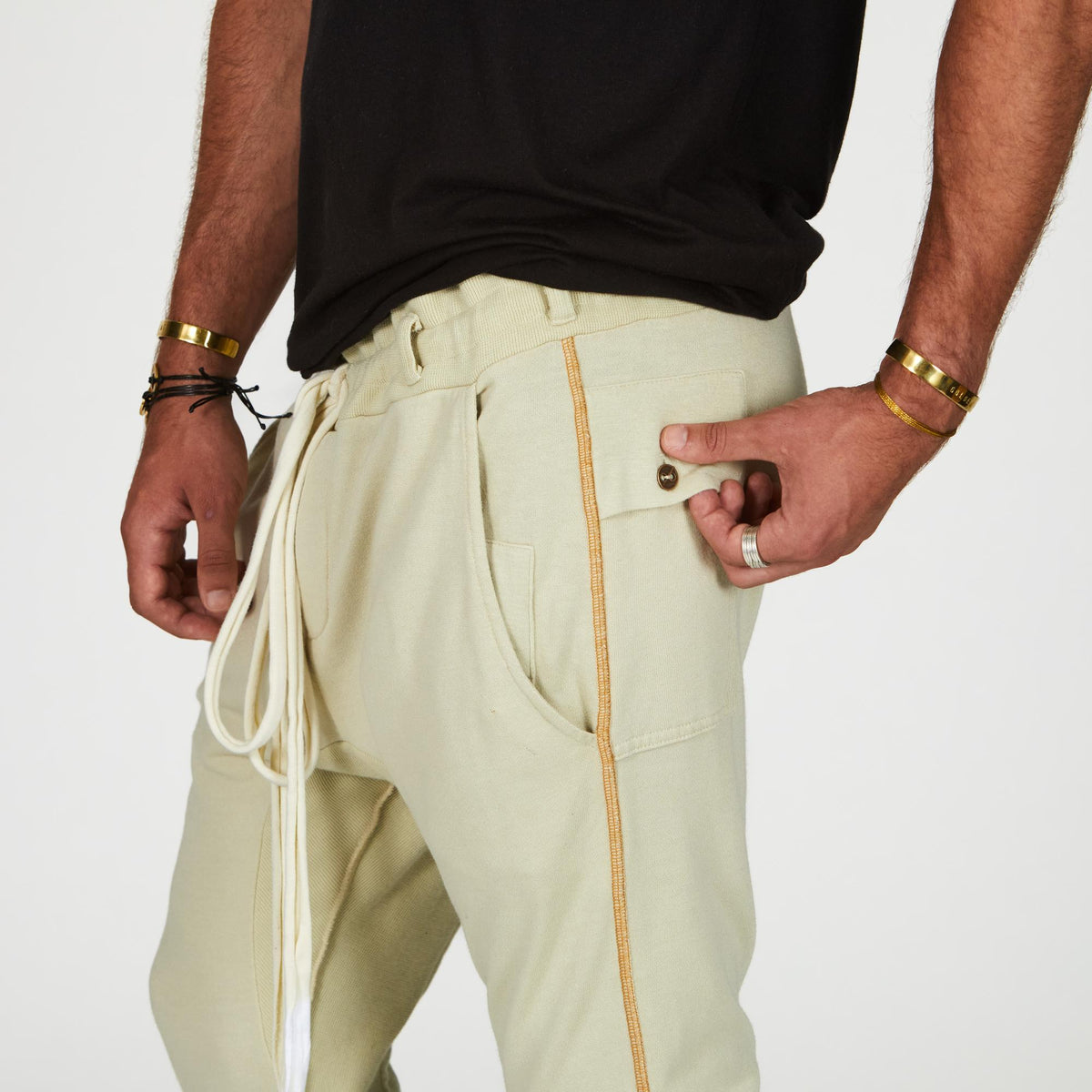 Man modeling the milano pant in ceremony sand