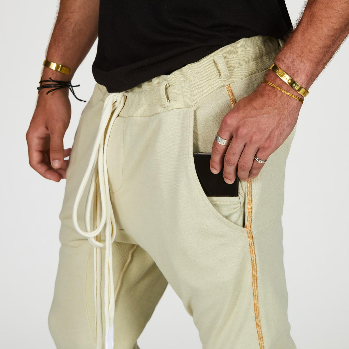 Man modeling the milano pant in ceremony sand