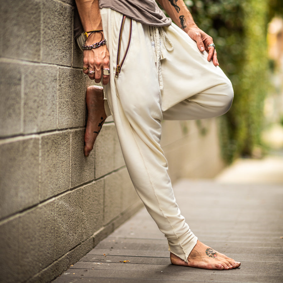 A man wearing the One Golden Thread Tree Pant in Ceremony Sand color