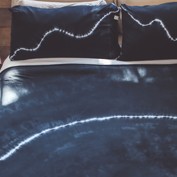 A set of the One Golden Thread Pillow Face Set in the Black Onyx Bolt color